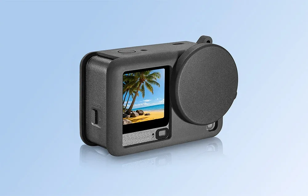 DJI Osmo Action 6 in a black silicone protective case with lens cover and beach view on the screen