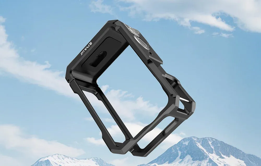 Close-up of the empty black metal protective cage for DJI Osmo Action 6 against a mountain and sky background.