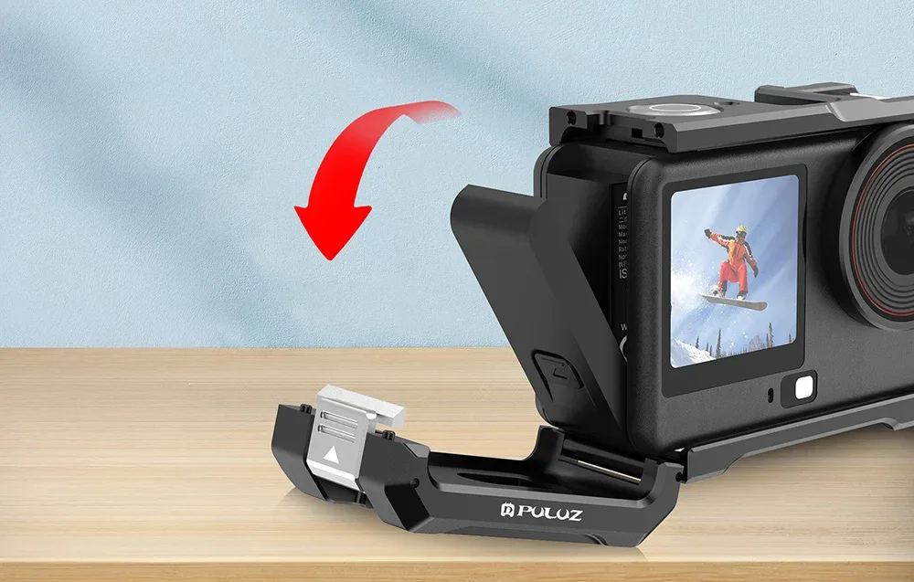 Open side door of the metal protective cage providing access to the charging port and battery compartment of the camera.