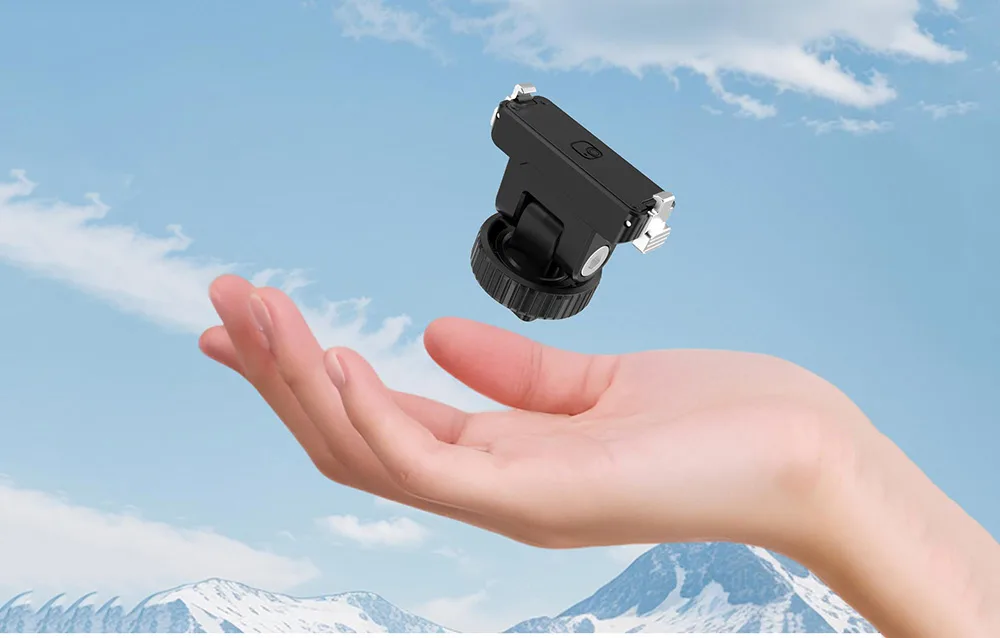 Puluz magnetic adapter displayed above an open hand with mountains and sky in the background