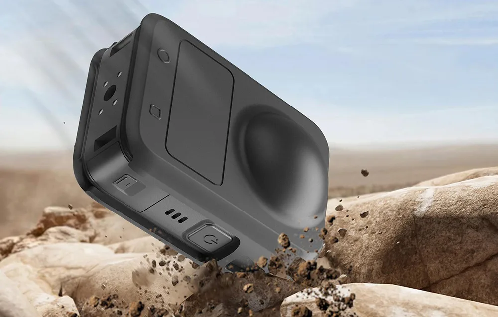 DJI Osmo 360 in a black silicone case falling onto rocky ground to illustrate impact protection