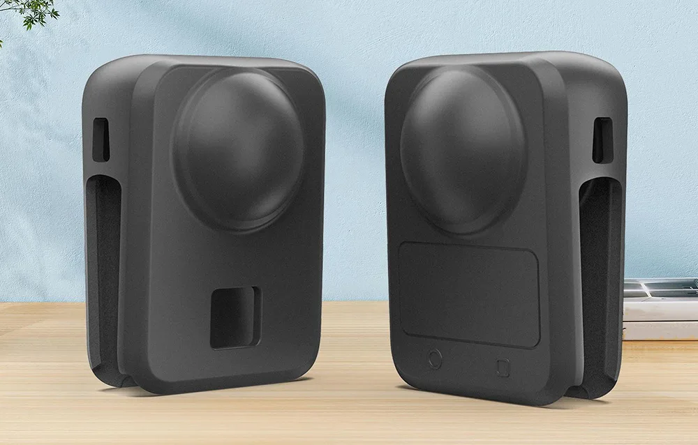 Black protective silicone covers for DJI Osmo 360 displayed from different sides on a wooden surface