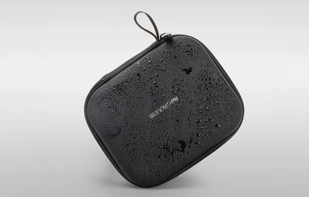 Black Sunnylife case covered with water droplets on a gray background