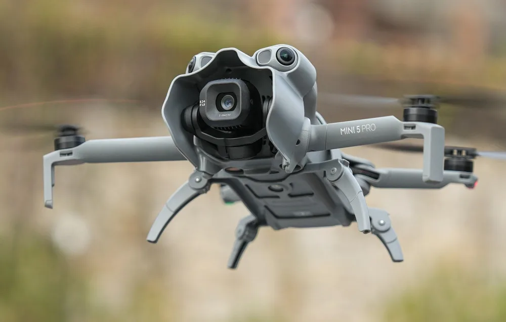 DJI Mini 5 Pro drone in flight with Sunnylife sun hood installed