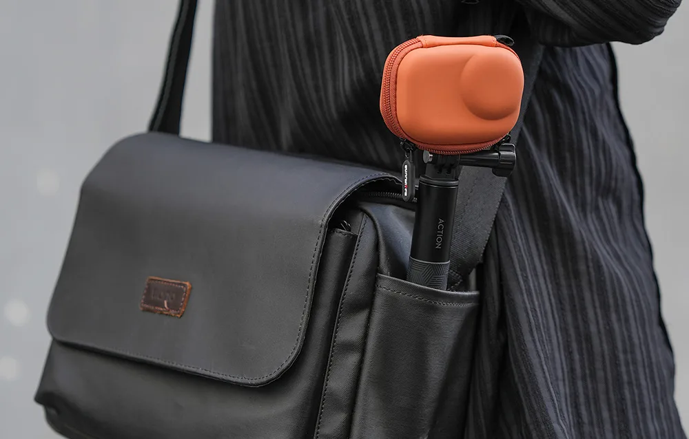 Sunnylife orange protective case stored in a black shoulder bag pocket