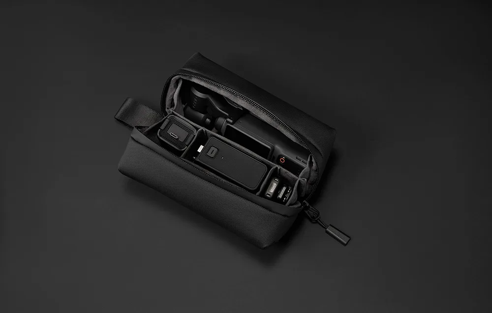 Open black carrying case with compartments for DJI Osmo Pocket 4 camera and dedicated accessories