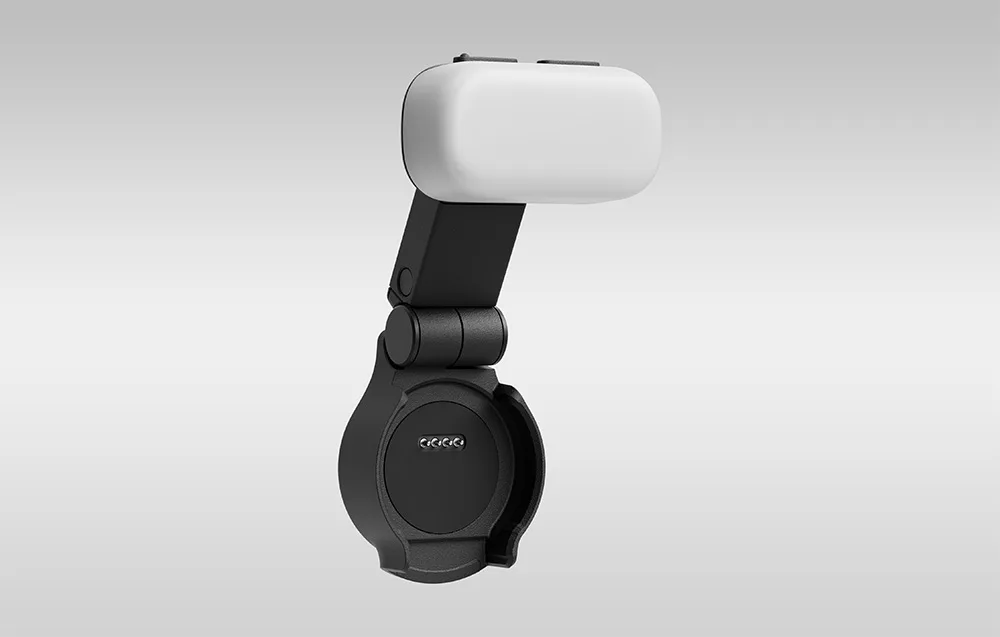 Close-up of the black mount with a white LED light, showing the contact pins and pivoting holder