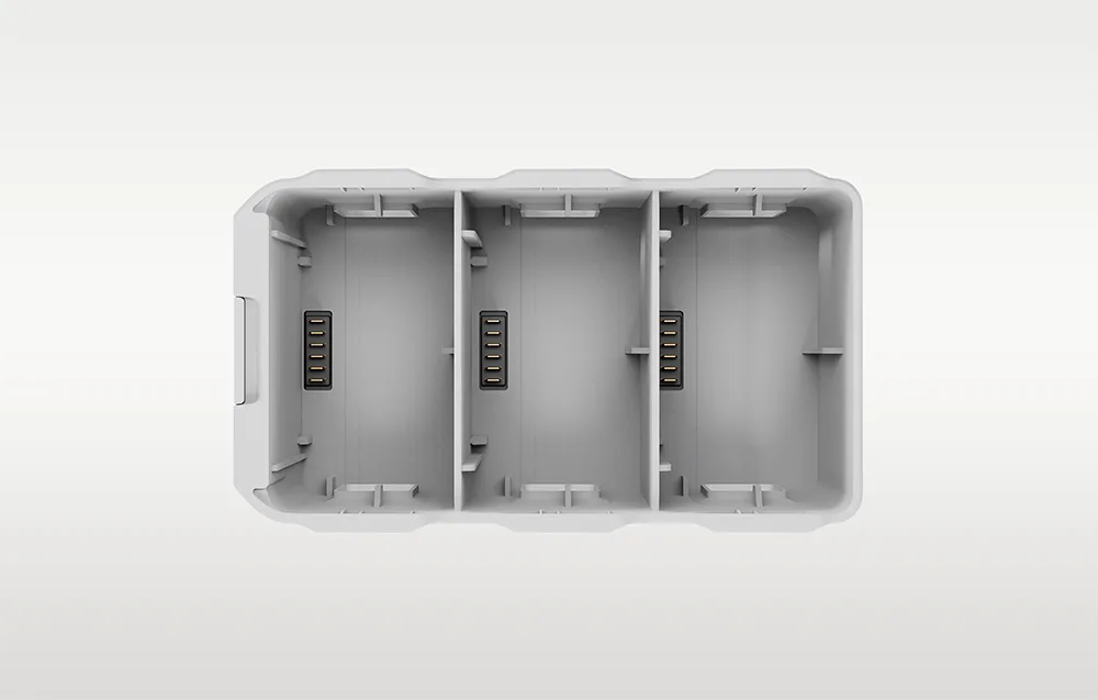 Light gray DJI Lito 1 two-way charging hub with three drone battery slots and internal charging contacts