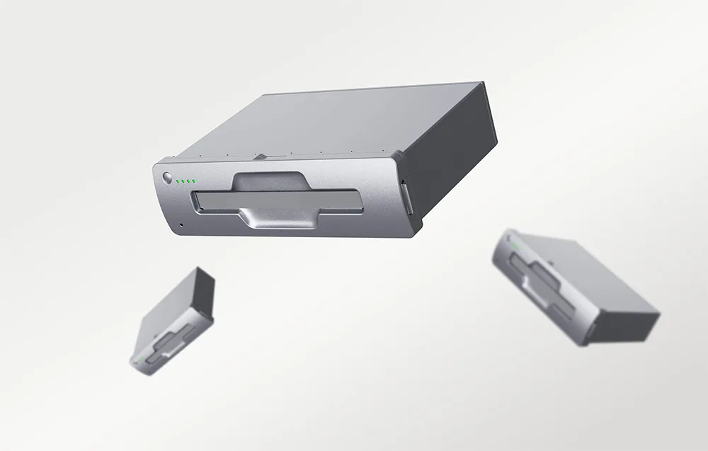 Three silver UNITREE robot batteries on a gray background