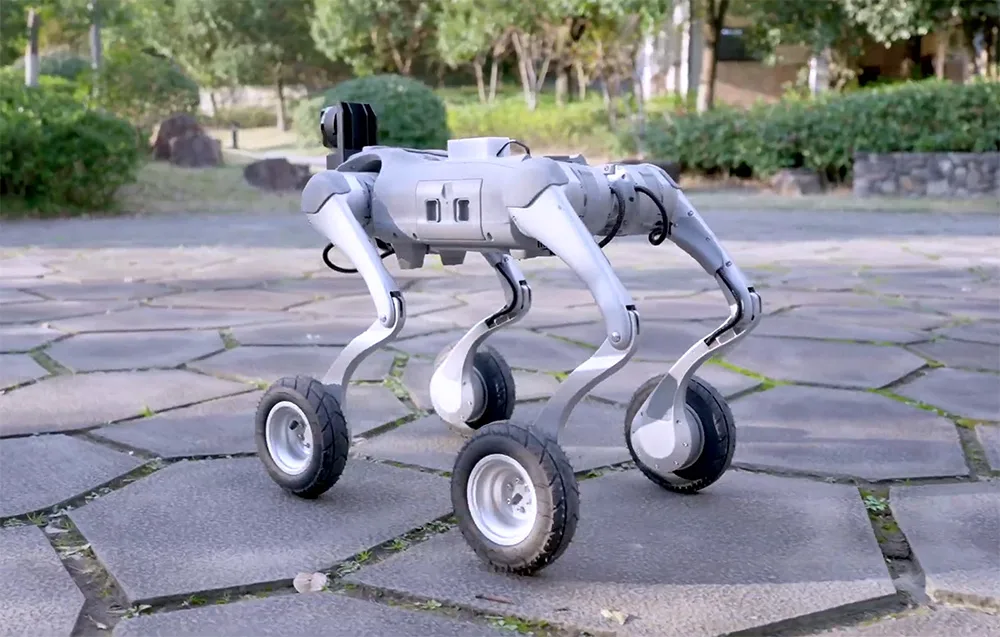 Unitree robot with wheels instead of feet standing outdoors on a paved square