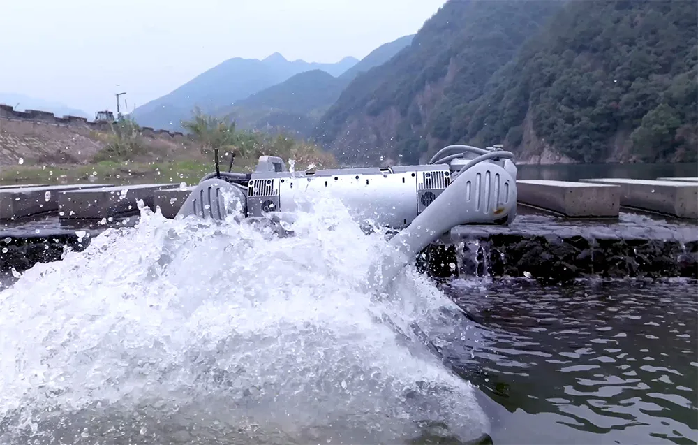 UNITREE B2-W robot partially moving through water near a concrete edge