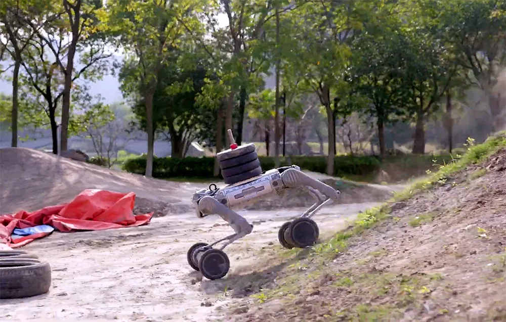 UNITREE B2-W robot with wheels on sandy terrain outdoors