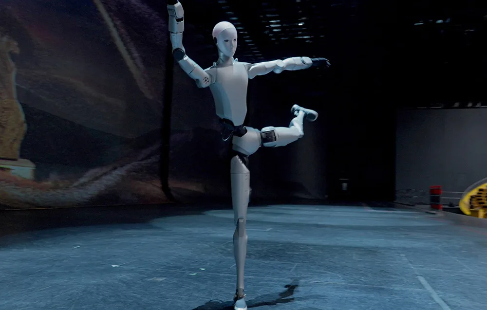 UNITREE H2 humanoid robot balancing on one leg in a dance-inspired pose