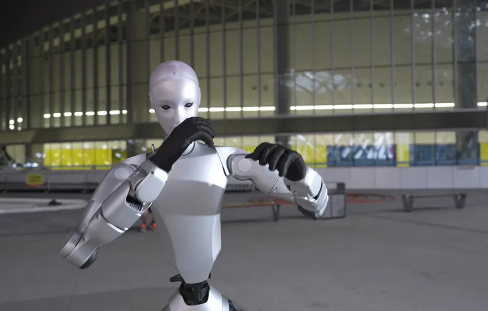 Close-up of the UNITREE H2 Edu humanoid robot performing precise hand gestures