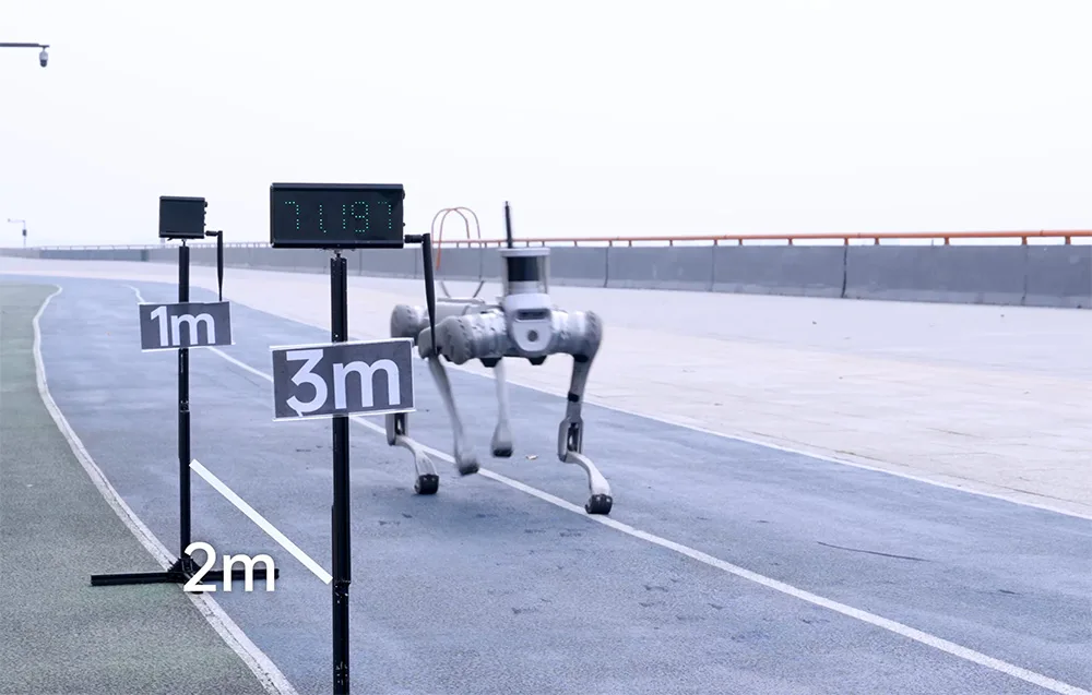 UNITREE B2 quadruped robot running on a test track with distance markers and a timer