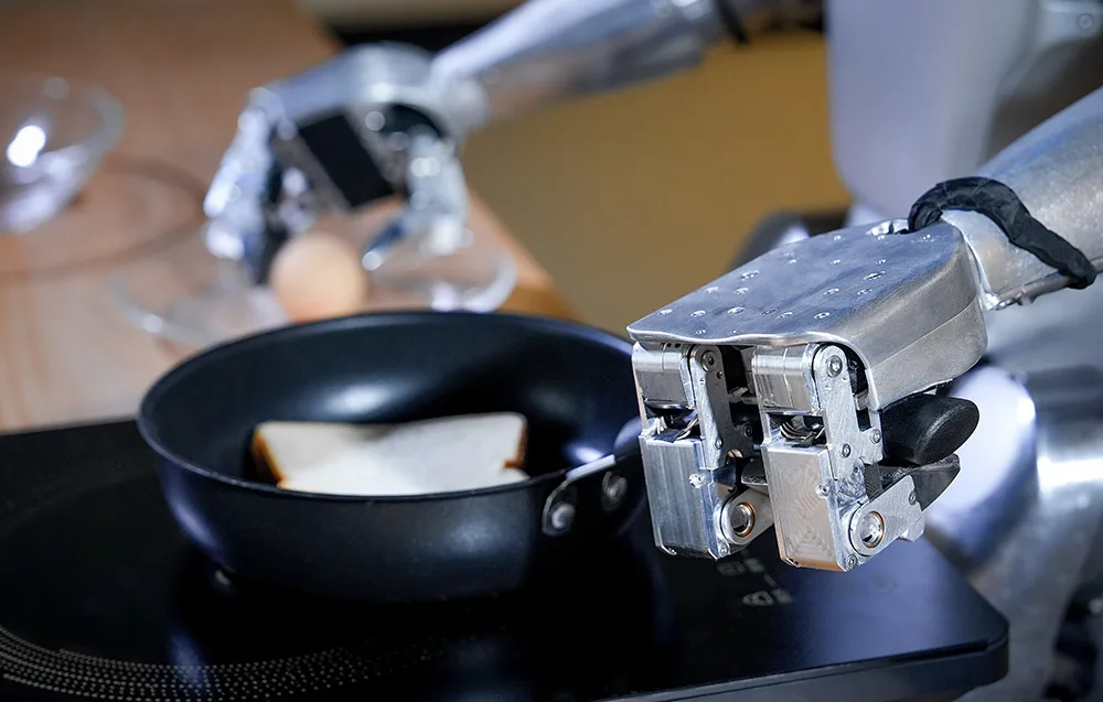 UNITREE humanoid robot frying toast in a pan and demonstrating high-dexterity robotic hands