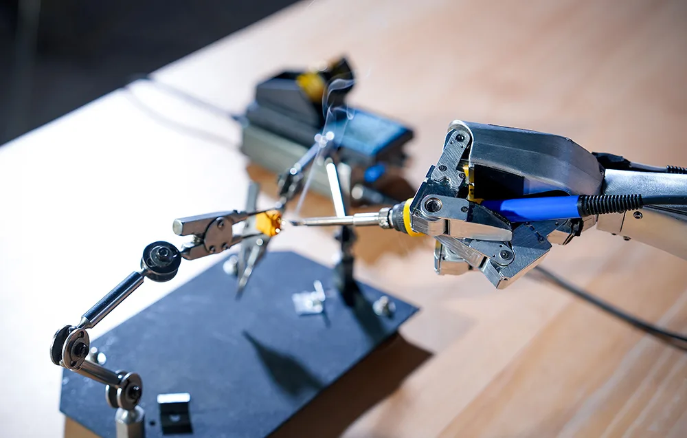 Precise UNITREE robotic arm soldering electronic components with a soldering station