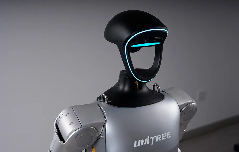 Close-up of the UNITREE robot head with signature blue LED lighting and built-in sensors
