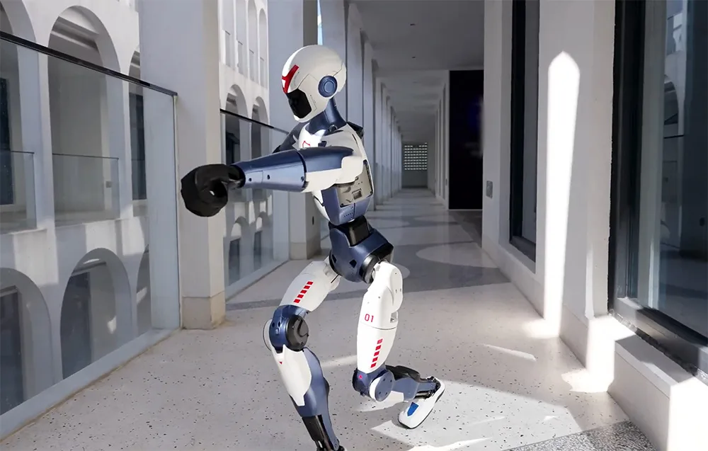 UNITREE R1 Edu U2 humanoid robot walking through a building corridor