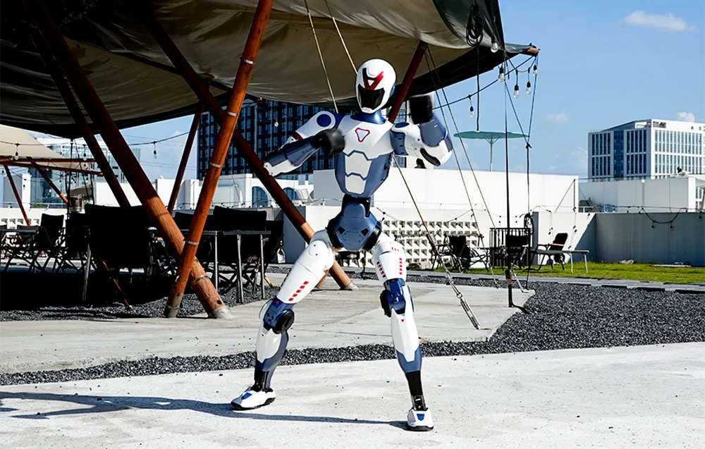 UNITREE R1 Edu U2 humanoid robot standing on a concrete surface under a tent