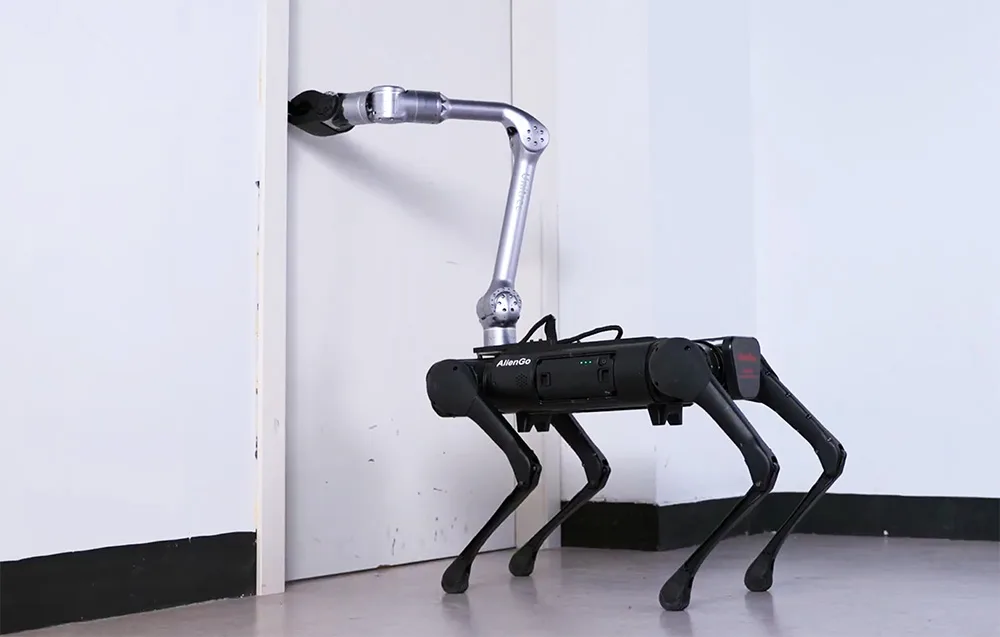 Quadruped robot equipped with a UNITREE manipulator arm opening a door