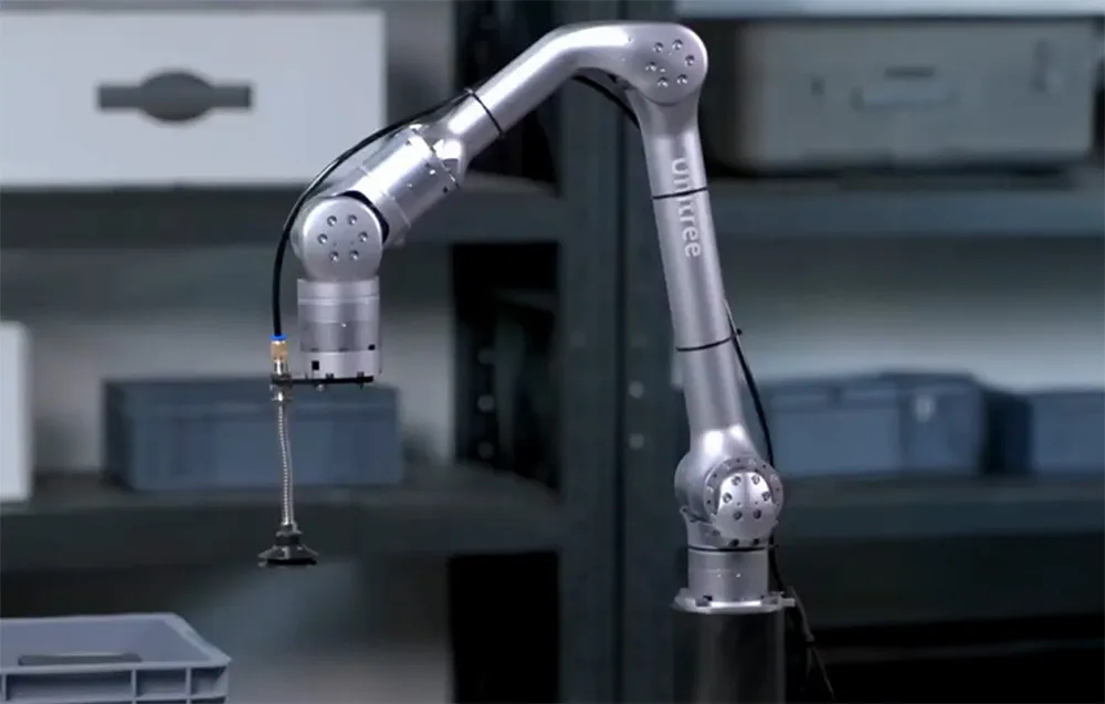 UNITREE Z1 Pro robotic arm with suction tool above a plastic container in a warehouse environment