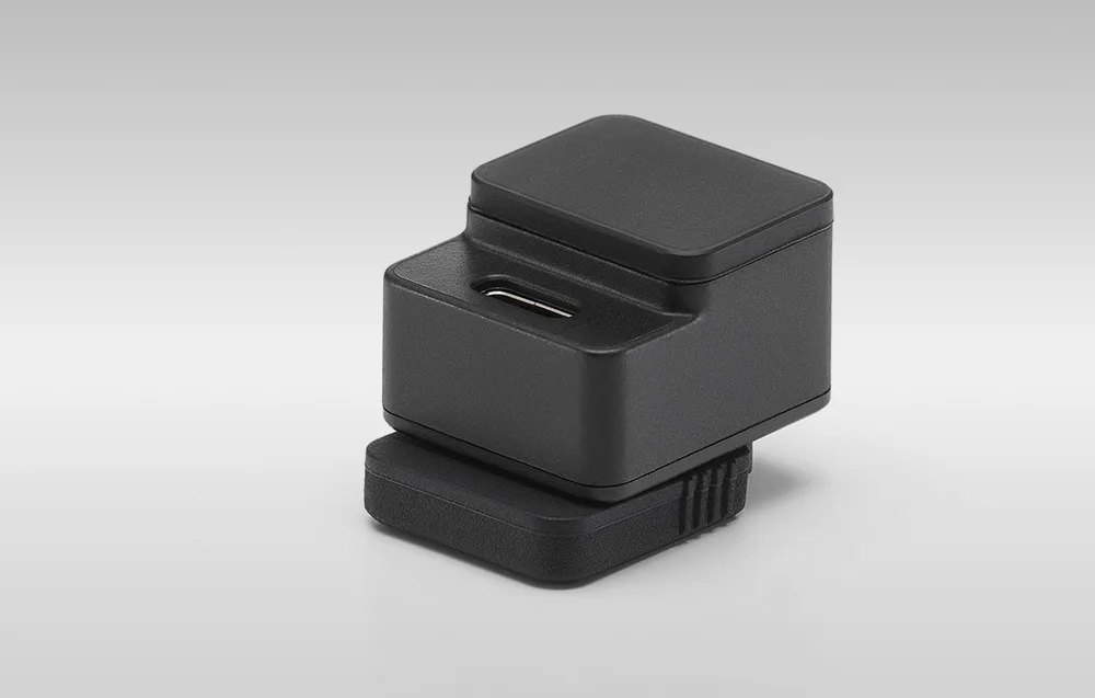 DJI Mic 3 camera adapter on a gray background