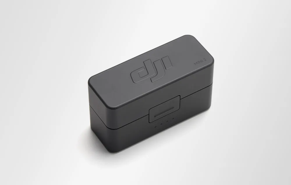 Szare etui ładujące widziane z góry pod kątem, z logo DJI oraz napisem MINI 2 na pokrywie