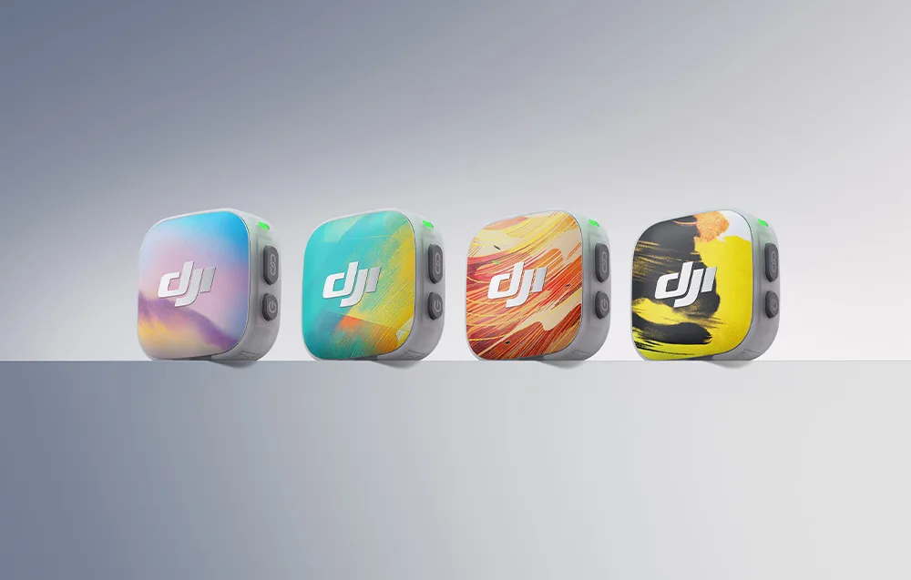 Four DJI Mic Mini 2 transmitters with colorful Time Series magnetic covers in purple, blue, orange, and yellow arranged in a row