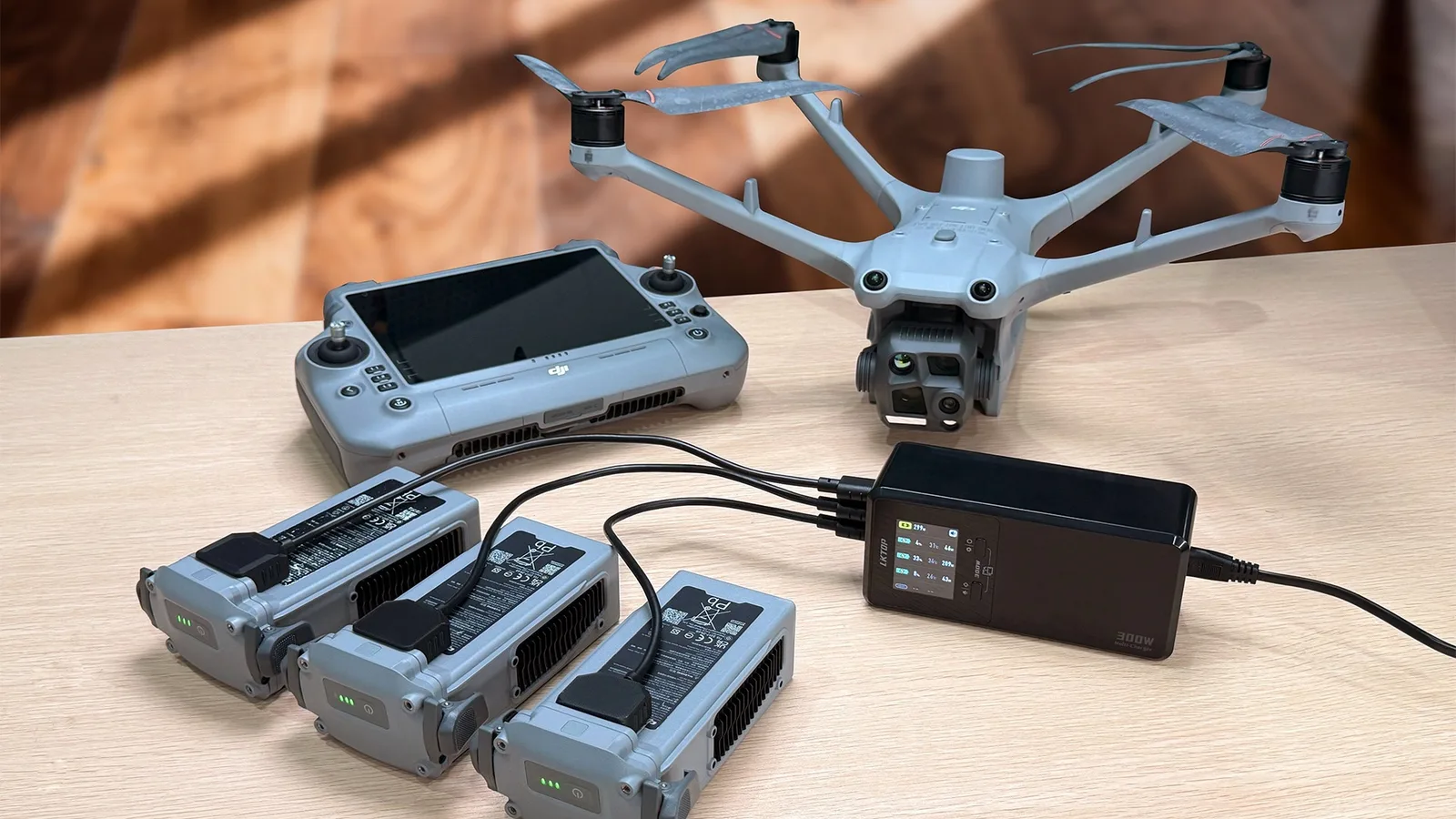 LKTOP 300W charger charging three DJI Matrice 4D and 4TD batteries