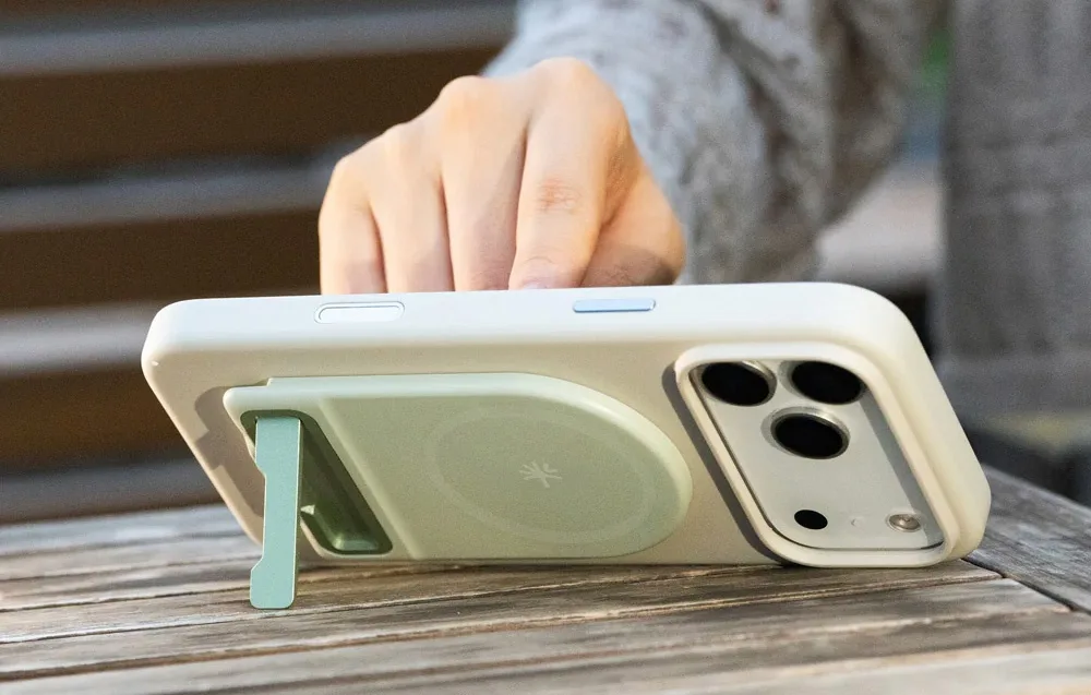 Smartphone placed horizontally on a table with the stand deployed on the back of the case