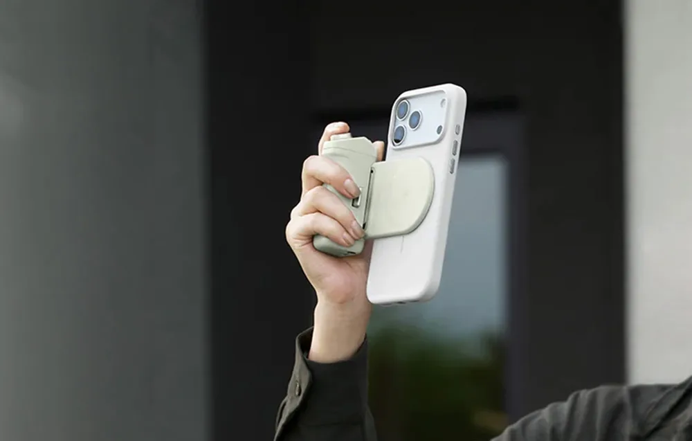 Person holding a smartphone with the PGYTech MagCam 2 grip attached while shooting vertically