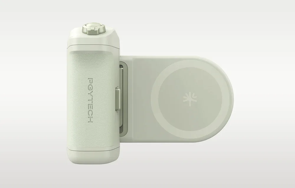 Green PGYTech MagCam 2 smartphone camera grip with visible button and circular module on a gray background