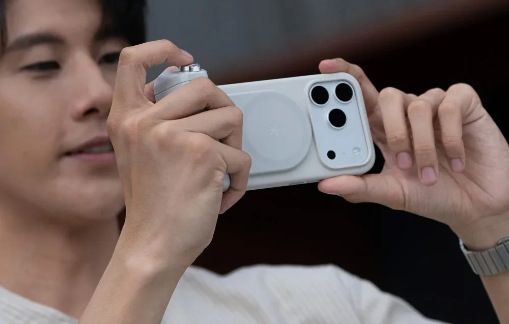 Person holding a smartphone with the PGYTech MagCam 2 grip in horizontal shooting mode