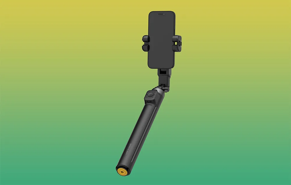 Biały gimbal ze smartfonem w pozycji pionowej na zielono-żółtym tle.