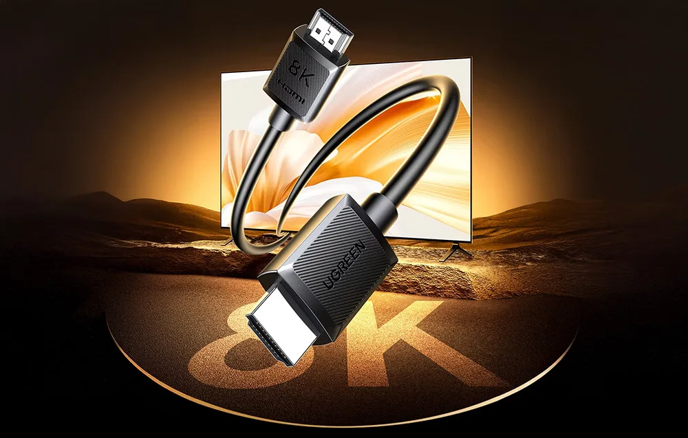 Kabel HDMI z logo 8K łączący dwa złącza na tle monitora wyświetlającego zachód słońca
