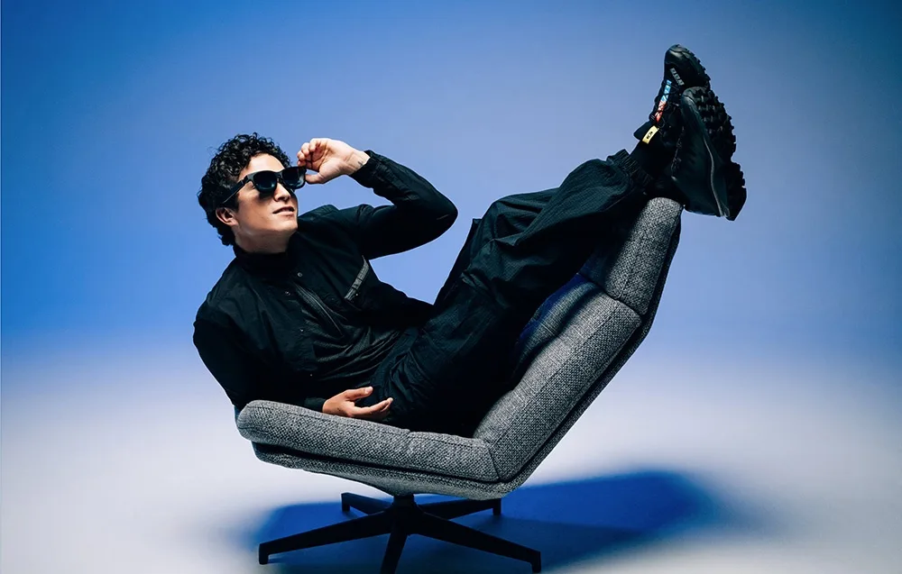 Man relaxing in an armchair while wearing VITURE XR Beast glasses.