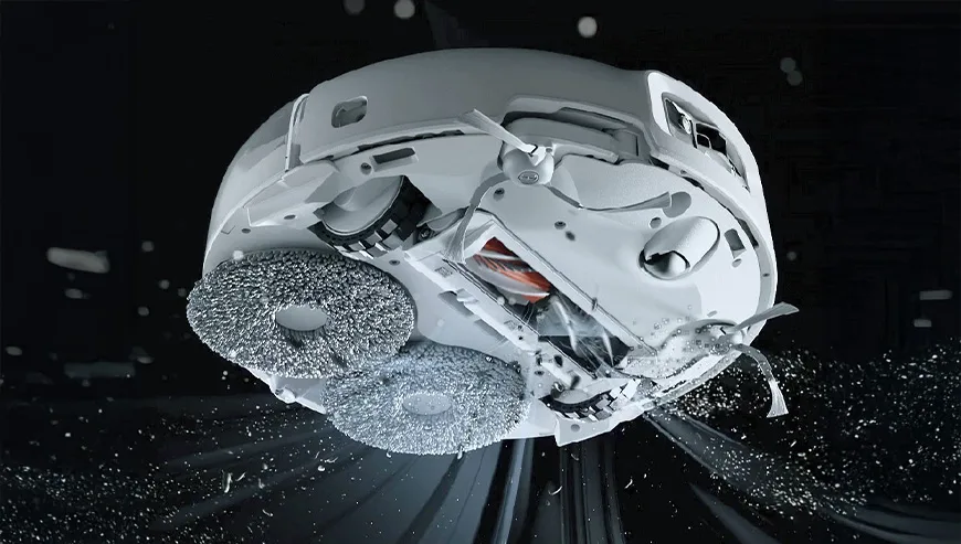 Bottom view of the DJI Romo robot vacuum with rotating cleaning brushes in action