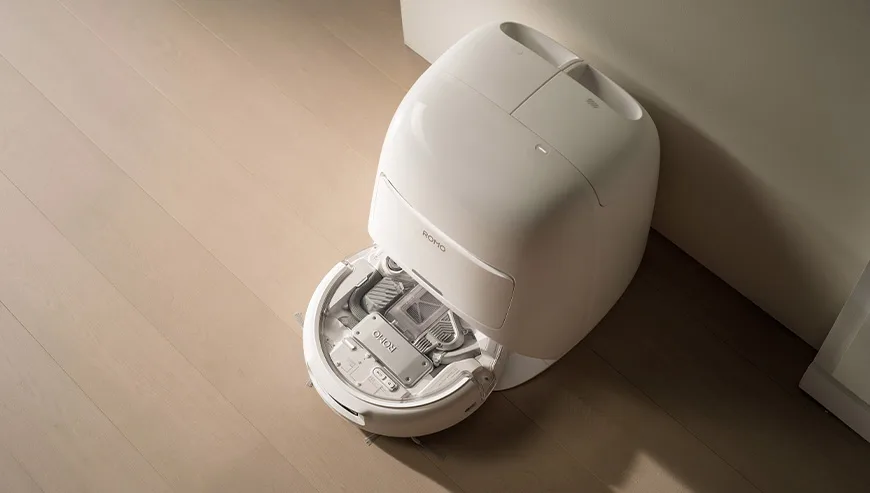 Top view of an open DJI Romo docking station with the robot inside